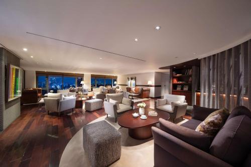 a living room with couches and chairs and a table at Banyan Tree Club & Spa Seoul in Seoul