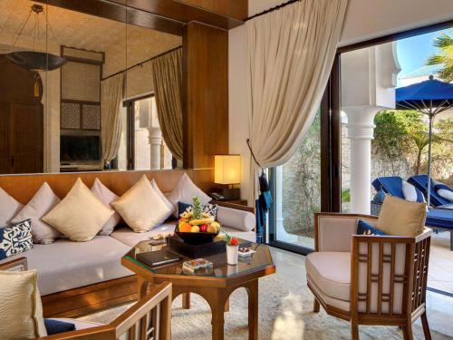 a living room with a couch and a table at Banyan Tree Tamouda Bay in Fnidek