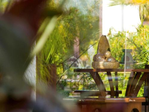 a sculpture of balls on a table in a garden at Banyan Tree Tamouda Bay in Fnidek