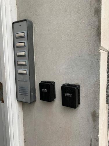 two electronic devices on a wall next to a door at Uplands View, Richmond Tce, Flat 1 in Swansea