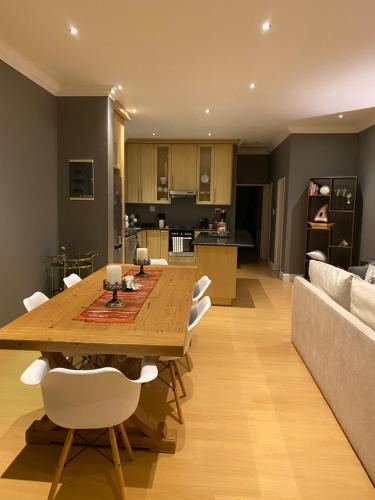 a dining room and living room with a table and a couch at Waves Edge CP3 in Cape Town