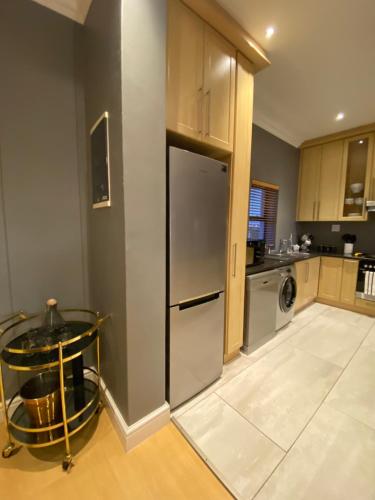 a kitchen with a stainless steel refrigerator and a dishwasher at Waves Edge CP3 in Cape Town
