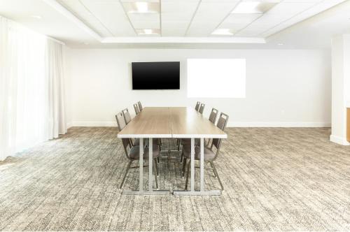 a conference room with a wooden table and chairs at Staybridge Suites - San Bernardino - Loma Linda in San Bernardino