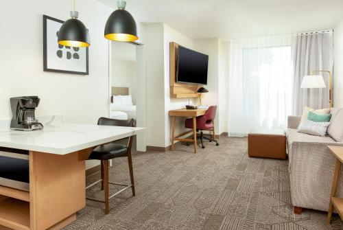 a living room with a couch and a table in a hotel room at Staybridge Suites - San Bernardino - Loma Linda in San Bernardino