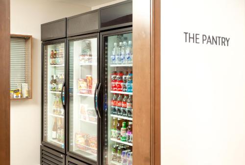 a refrigerator filled with lots of soda and drinks at Staybridge Suites - San Bernardino - Loma Linda in San Bernardino