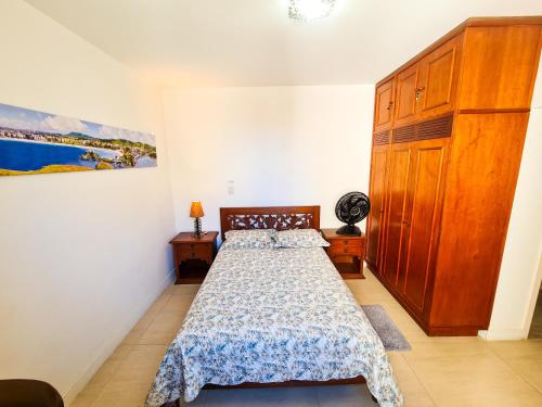 um quarto com uma cama e um quadro na parede em Apartamento pé na areia - Praia do Forte em Cabo Frio