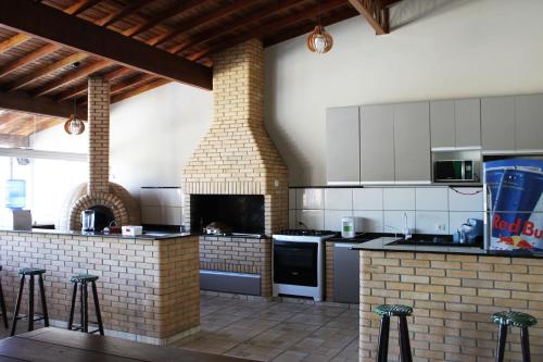 uma grande cozinha com forno de tijolos e balcões em Chacara com piscina e muito lazer em Jarinu SP em Jarinu