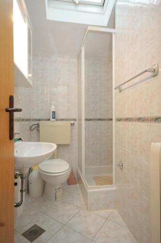 a bathroom with a shower and a toilet and a sink at Apartments by the sea Preko, Ugljan - 8515 in Poljana