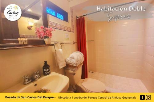 a bathroom with a toilet and a sink and a shower at Posada de San Carlos del Parque in Antigua Guatemala