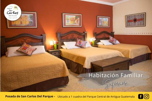 a hotel room with two beds with orange walls at Posada de San Carlos del Parque in Antigua Guatemala