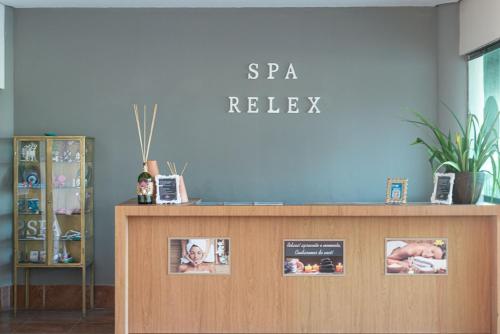 a reception desk with pictures on the wall at Flat ou Bangalo Luxo Beach Class Beira Mar Muro Alto in Porto De Galinhas