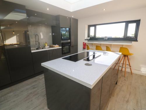 a kitchen with a large island in the middle at Craybourne in Falmouth