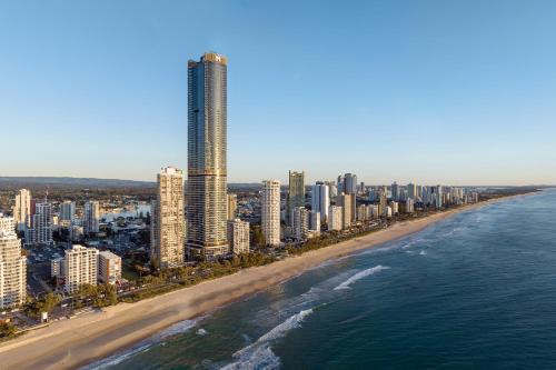 an aerial view of a beach with buildings and the ocean at Meriton Suites Surfers Paradise in Gold Coast