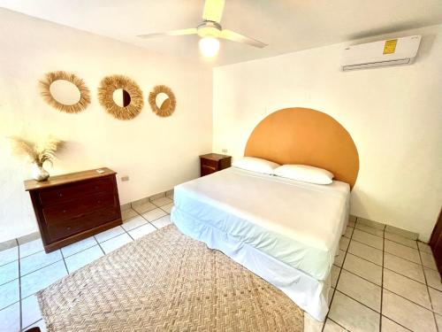 a bedroom with a bed and a ceiling fan at Casa Umay in Bacalar