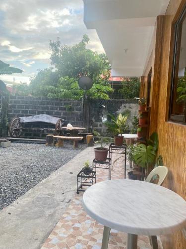 a patio with a table and chairs and a fire place at Alona's Traditional Filipino Home near 100 Islands Wharf in Alaminos