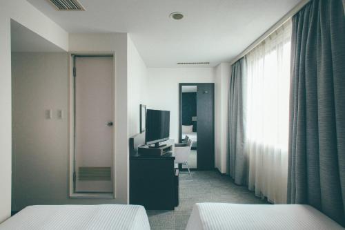 Postel nebo postele na pokoji v ubytování Hamilton Hotel Black