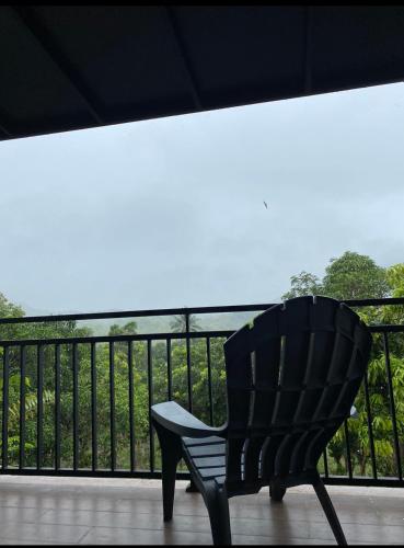 a black chair sitting on top of a balcony at Hakata Lejja near Natural Hot spring in Batu-Batu