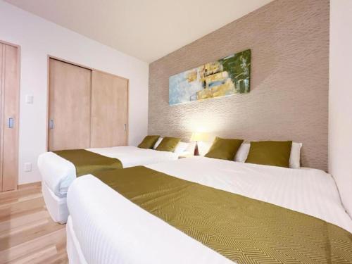 Postel nebo postele na pokoji v ubytování OWL RESORT ARIFUKU ONSEN
