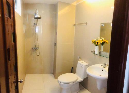 a bathroom with a shower and a toilet and a sink at Q.MIN apartment in Nha Trang