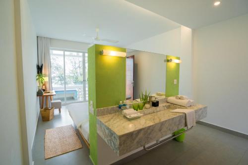 a bathroom with a large sink and a large mirror at Naiya Sea Resort in Sihanoukville