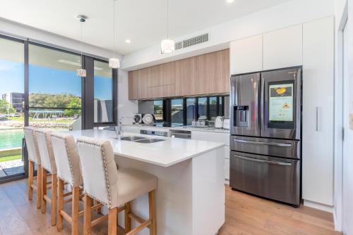 a kitchen with a large island and a refrigerator at Maraboo Island Beachfront Villa in Fremantle