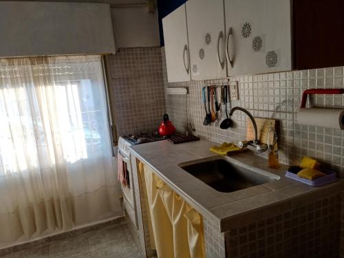 a kitchen with a sink and a counter top at PUNTO FIJO in Zárate