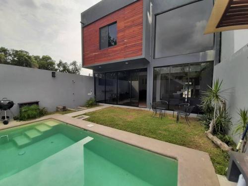 a house with a swimming pool in front of it at Villa Copa de Oro. Zona Diamante. Alberca Privada. Espacio Yocte in Acapulco