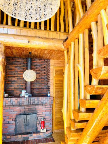 a living room with a fireplace in a log cabin at 民泊JOYFUL天然温泉付きログハウス in Shiraoi