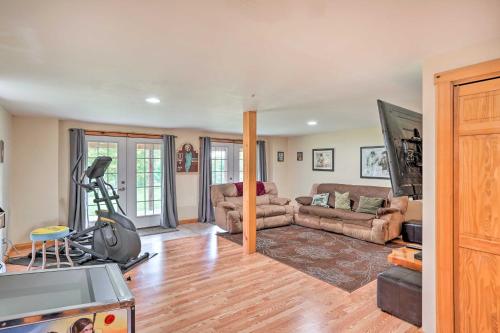 a living room with a couch and a gym at Grand Windham Retreat with Fire Pit and Game Room in Windham