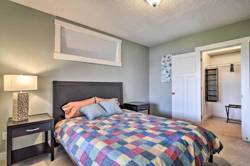 a bedroom with a bed with a colorful blanket at Incredible Oregon Retreat with Private Hot Tub! in The Dalles