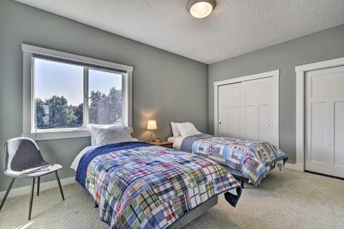 a bedroom with two beds and a window at Incredible Oregon Retreat with Private Hot Tub! in The Dalles