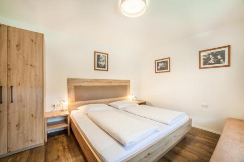 a bedroom with a large bed with white sheets at Parigger Apt Lavendel in Racines