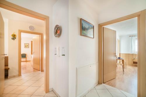 a hallway with a door leading to a living room at Parigger Apt Zirbe in Racines