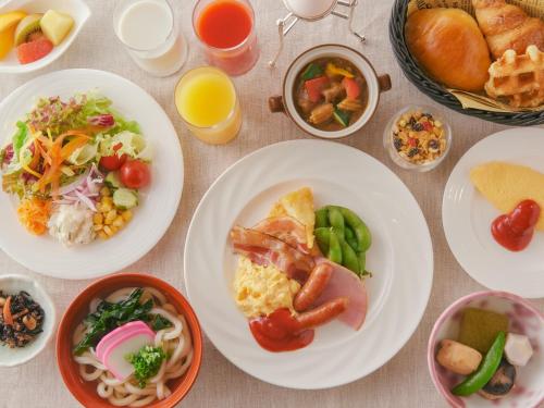 a table topped with plates of food and bowls of food at Takamatsu Kokusai Hotel in Takamatsu