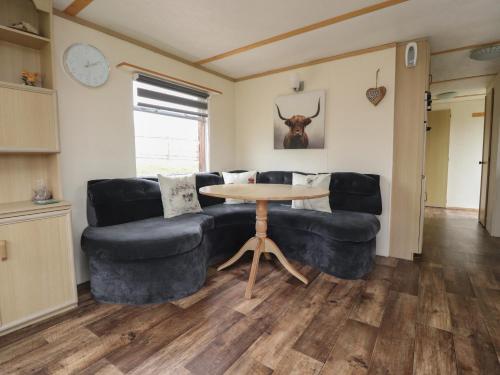 a living room with a couch and a table at Hillcrest Croft in Preston