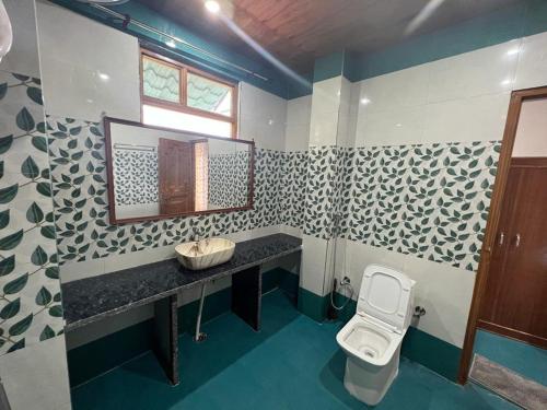 a bathroom with a sink and a toilet at Ramneek Homestay in Joshīmath