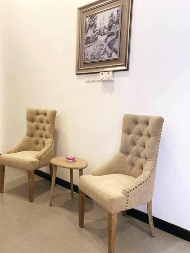 two chairs and a table in a room at Serenity Villa Dambulla in Sigiriya