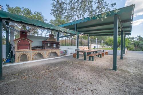 a picnic shelter with a building and a picnic table at St Nicholas B4 Beach Garden View I in Dafnila