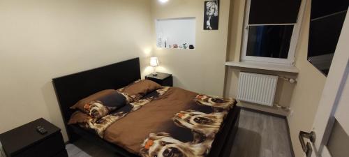 a bedroom with a bed with dogs on it at Apartament CENTRUM in Sosnowiec