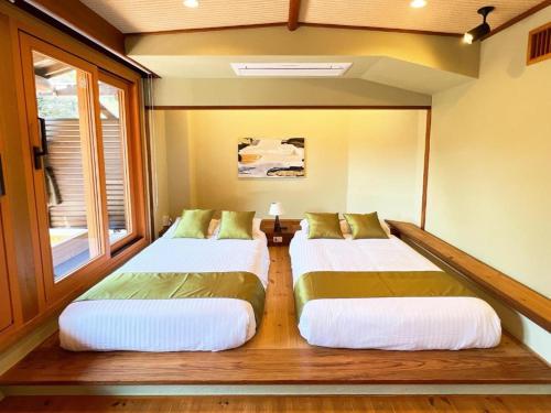 Postel nebo postele na pokoji v ubytování OWL RESORT ARIFUKU ONSEN