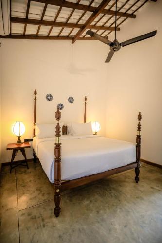 a bedroom with a bed with two lamps on it at Moi Talpe by DBI in Talpe