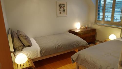 a bedroom with two beds and a dresser and a window at Modern Seaside Townhouse feat Sauna near Brighton in Shoreham-by-Sea