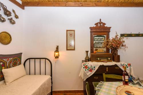 a room with a bed and a table and a chair at Eros Pittoresque Retreats - Perfect location, Panoramic Seaview in Koroni