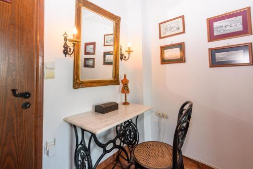 a room with a table and a mirror and a chair at Eros Pittoresque Retreats - Perfect location, Panoramic Seaview in Koroni