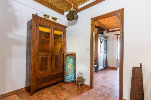 a room with a wooden cabinet and a tiled floor at Eros Pittoresque Retreats - Perfect location, Panoramic Seaview in Koroni