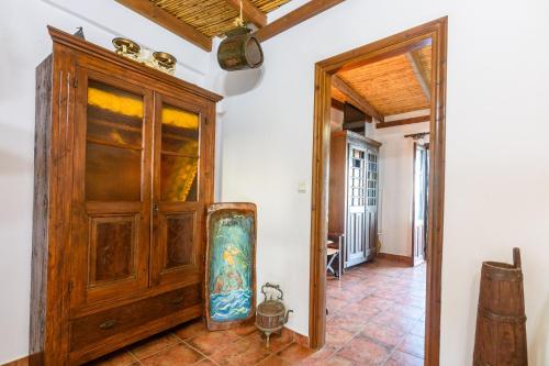a room with a wooden cabinet and a door at Eros Pittoresque Retreats - Perfect location, Panoramic Seaview in Koroni