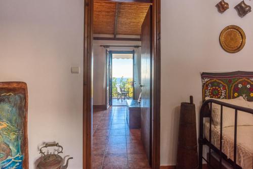 a hallway of a house with a room with a bed at Eros Pittoresque Retreats - Perfect location, Panoramic Seaview in Koroni