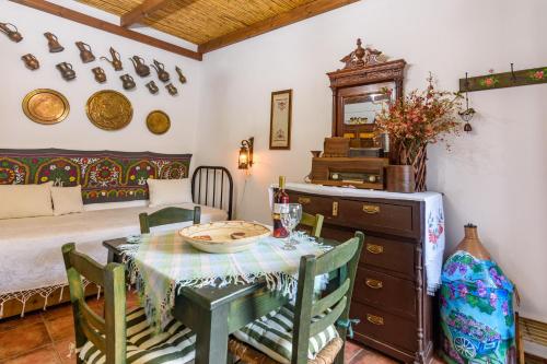 a dining room with a table and a bed at Eros Pittoresque Retreats - Perfect location, Panoramic Seaview in Koroni