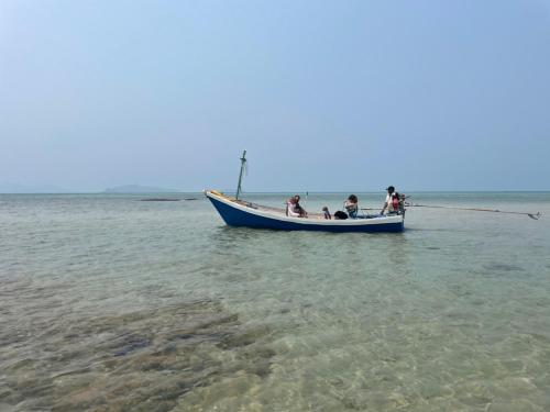 a group of people in a blue boat in the water at Koh Mak Green View Resort in Ko Mak