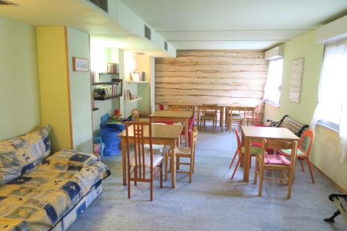 a dining room with tables and chairs in a room at appartamento Artesina in Sella della Turra